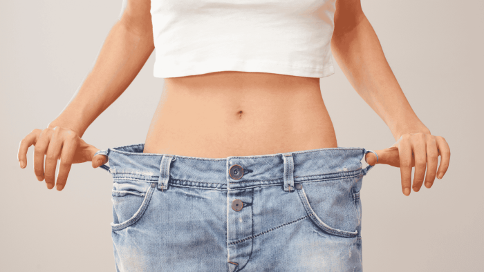 Kuvituskuva, jossa nainen esittelee löystyneitä farkkuja laihtumisen merkiksi